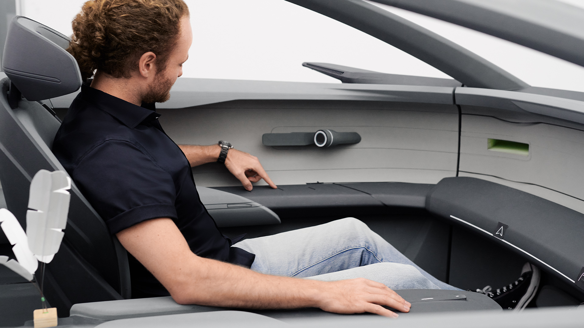 Designer Bartos Scharmach inside the model of the Audi grandsphere concept’s{ft_concept-vehicle} interior.