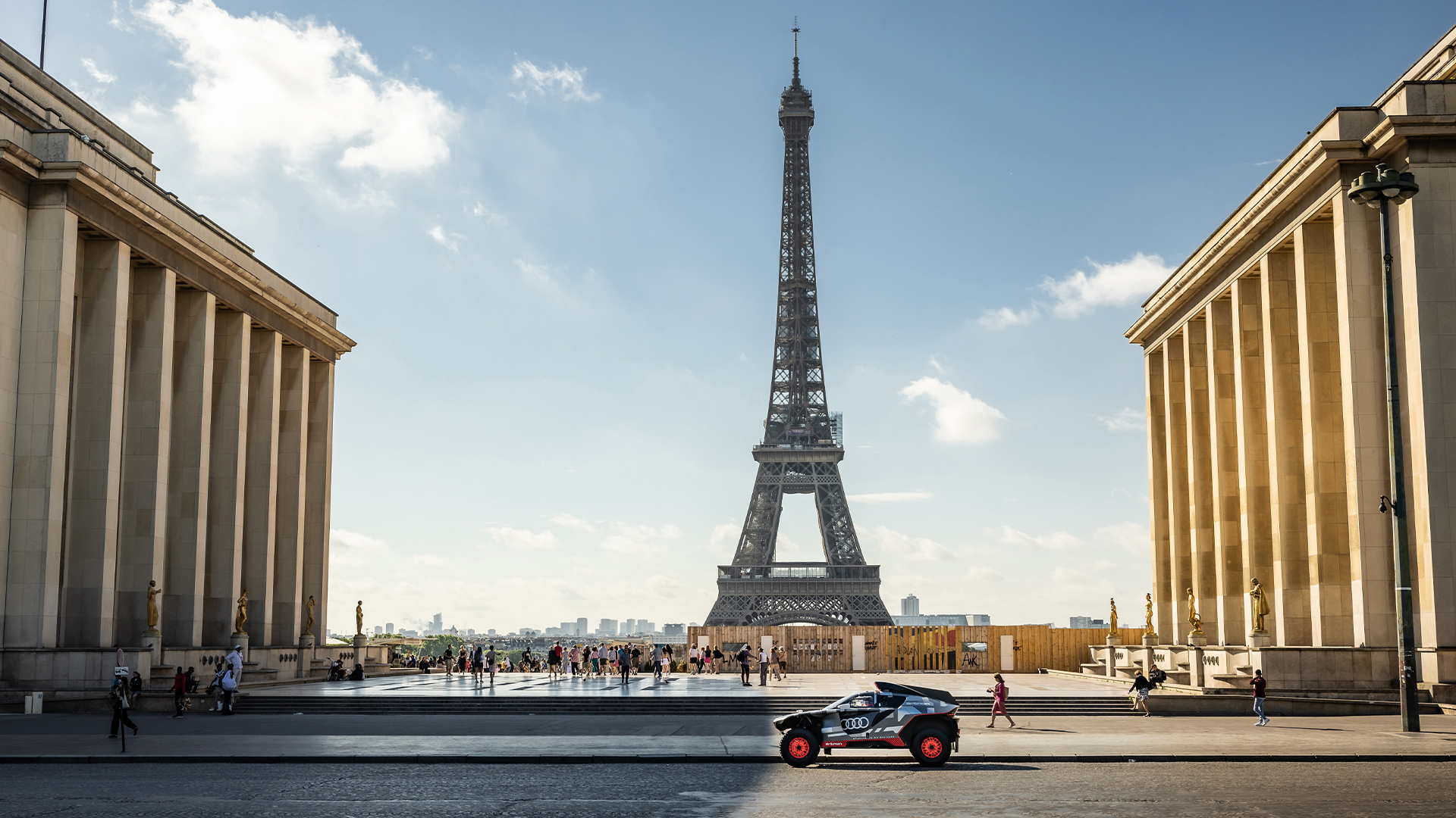 The Audi RS Q e-tron parked on a street. The Eiffel Tower can be seen in the background.