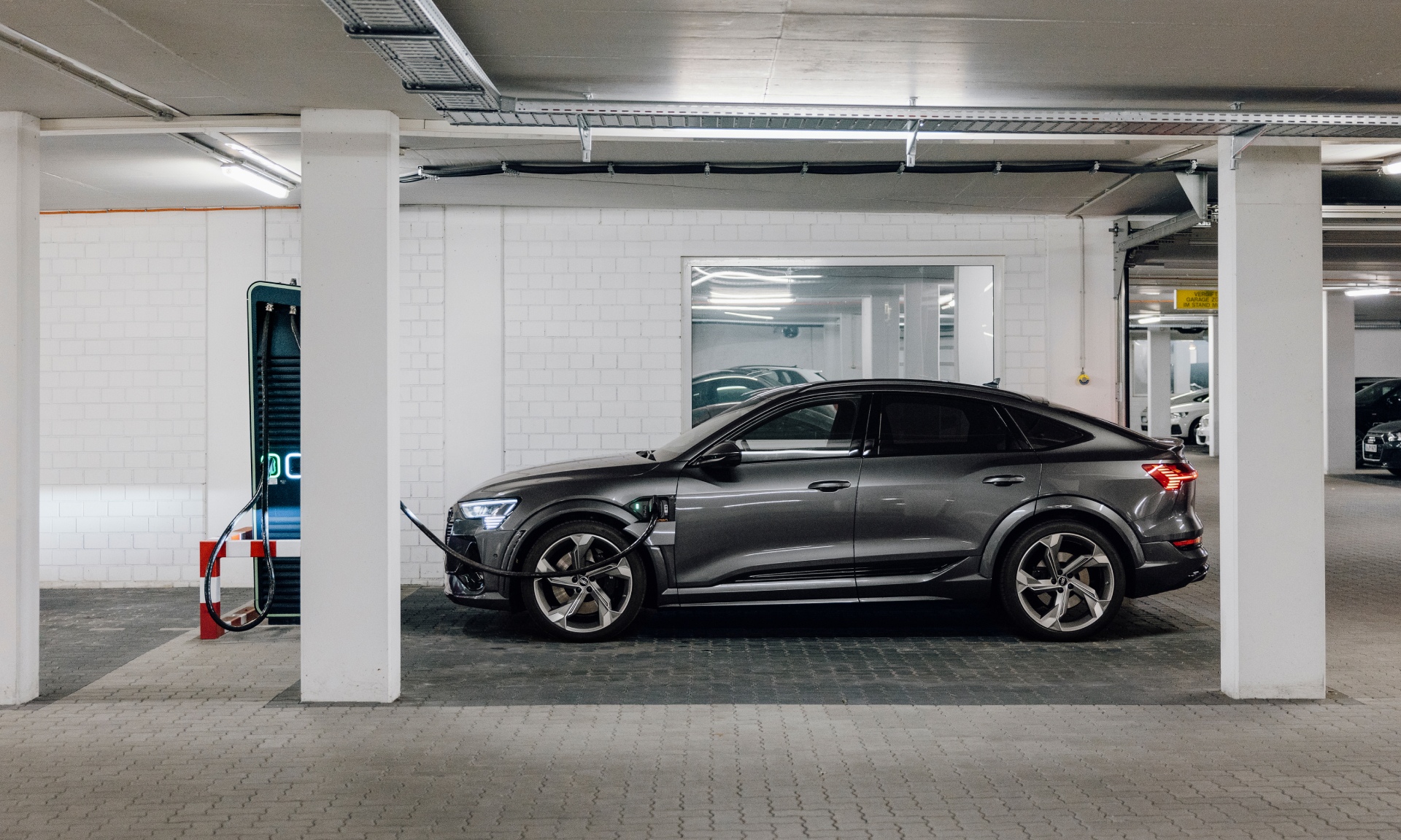 The Audi e-tron S Sportback charges in the underground car park.